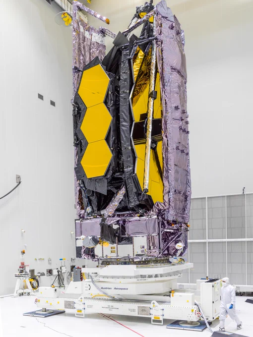 Telescope folded in its preparations facility, its signature honeycomb mirrors visible. 