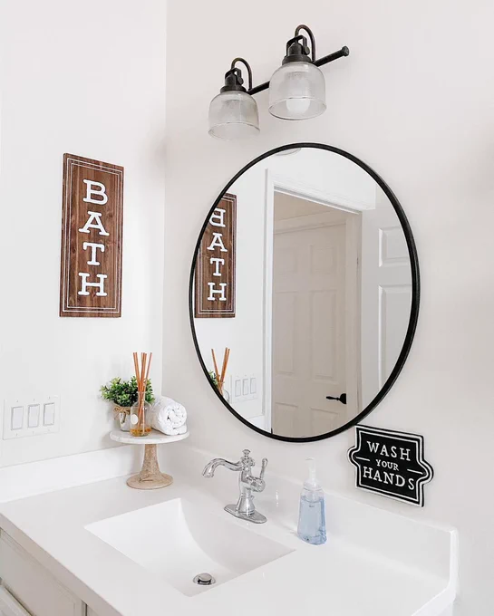 Bathroom with Dial foaming hand wash by the sink and "Bath" sign on the wall.