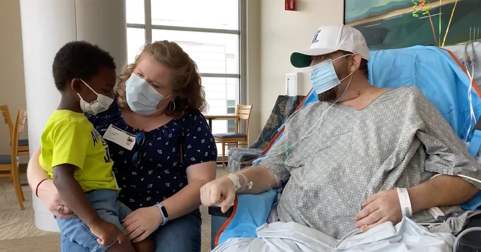 Matthew Moore visits with wife Rachel and son Marshall earlier this year following heart implantation surgery.