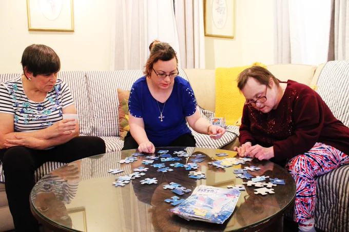 women  working together on puzzle