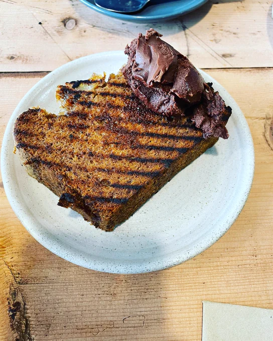 It’s a white plate. And on it is mouth heaven. A big chunky slab of banana bread that’s been toasted. At one end of it is a decent amount of chocolate butter (who knew such a thing existed), ready to be spread across the whole thing. It was so good I nearly cried.