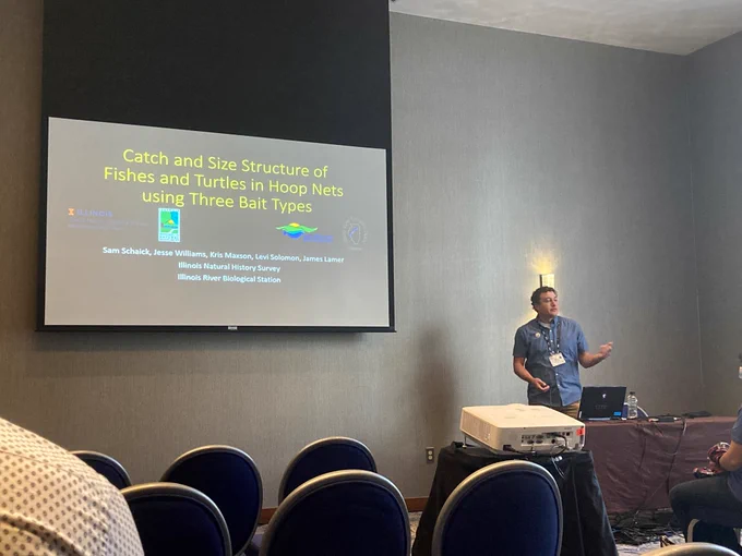 Staff biologist Sam Schaick describes fish and turtle catch using three different bait types on the Illinois River.