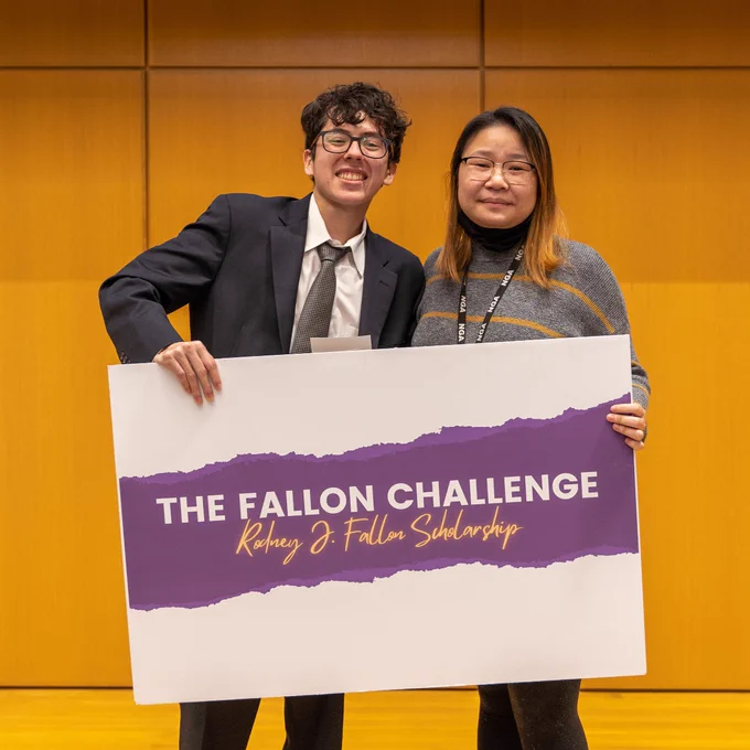 Robert Aguillen with a female guest holding a sign that says The Fallon Challenge Rodney J. Fallon Scholarship