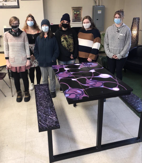 Students with completed picnic table - graphically painted 