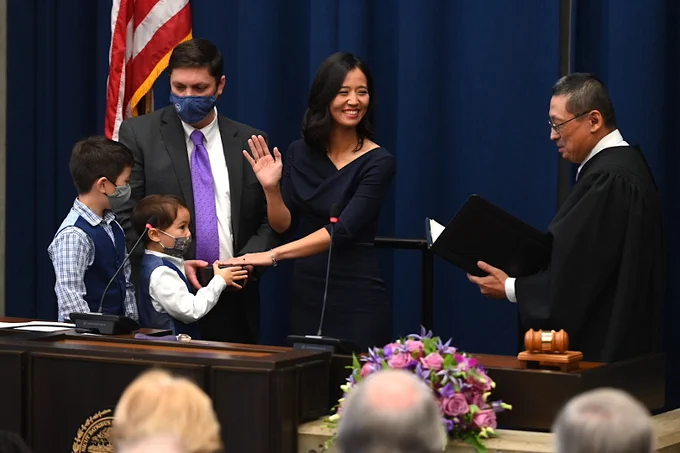 Michelle places her hand on a Bible held by her husband and two sons as Judge Myong Joun reads her the oath of office.