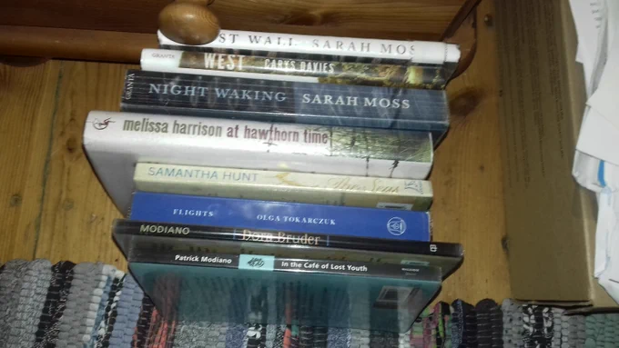 8 library books in a pile. 