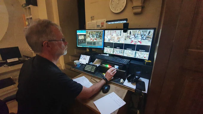Man works on a live stream on computer 