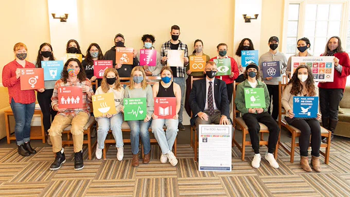 Group of students and Dr. Peter Ricketts at the signing of the United Nations Sustainable Development Goals Accord (SDG) on November 24, 2021. 