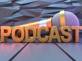 Photo of the text podcast in front of a microphone.