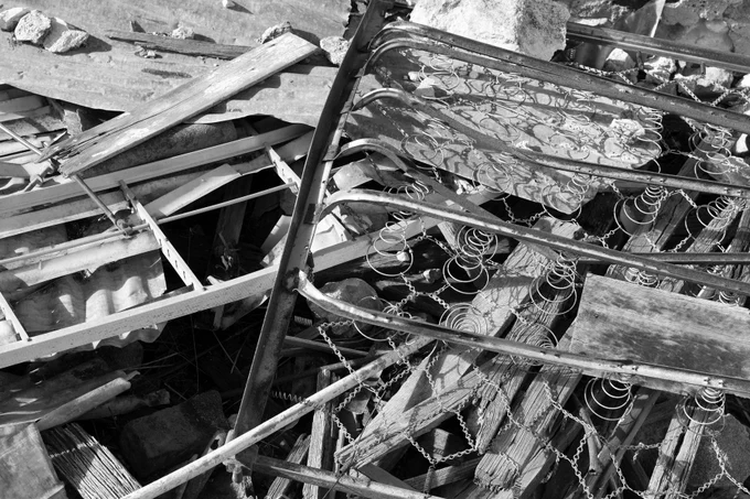 close up of ruins of a building with bedsprings