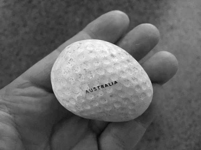 misshapen golf ball with 'Australia' written on it