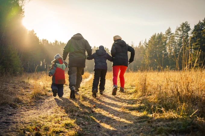 Family enjoying a walk in a field. 