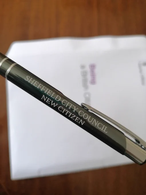 Metal pen with white paper in the background. On pen is written: "Sheffield City Council New Citizen". 