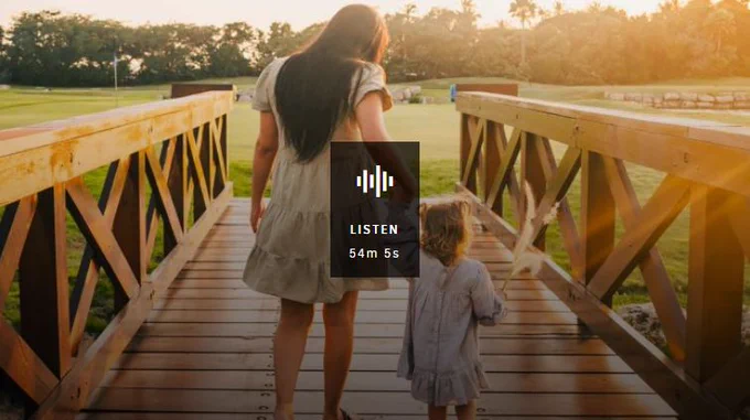 Mother and child walking across wooden bridge