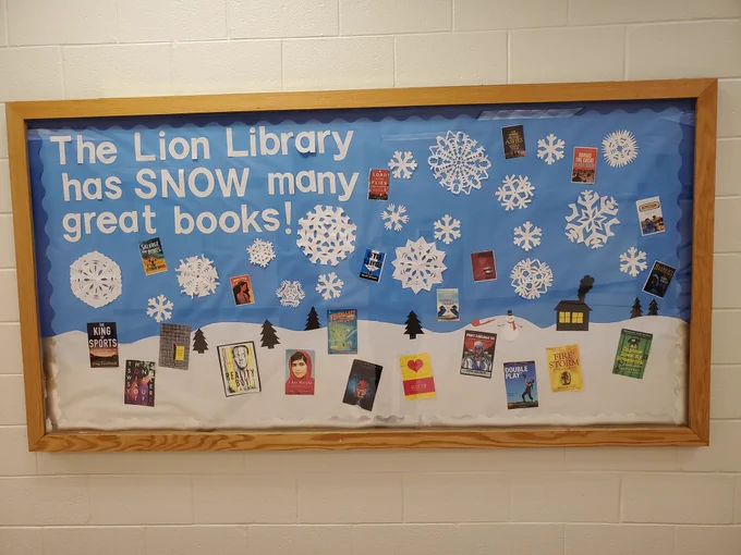 Bulletin board reads: The Lion Library has "snow" many books!