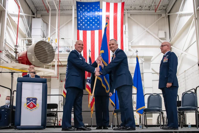 Brig. Gen. Gary McCue, director of the joint staff for the Ohio National Guard, hands the ceremonial guidon to Col. Darren E. Hamilton, incoming commander, during the 179th Airlift Wing change of command ceremony at Mansfield Lahm ANGB, Ohio, Dec. 3, 2021. The passing of a unit’s guidon symbolizes a transfer of command. Col. Todd K. Thomas is retiring as Col. Darren E. Hamilton takes command. (U.S. Air National Guard photo by Master Sgt. Joe Harwood)