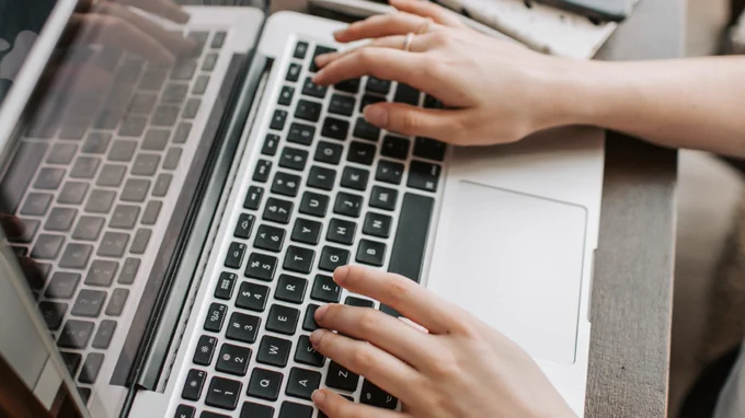 Instructor typing on laptop