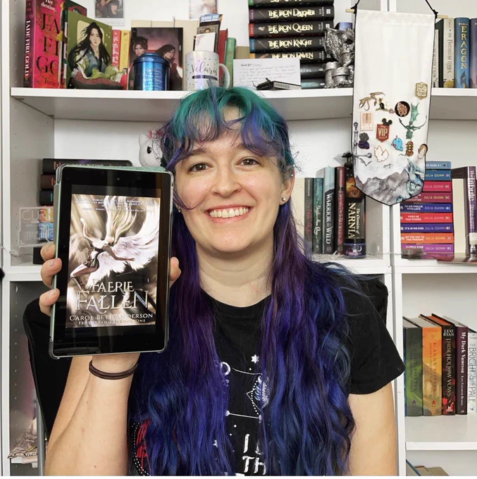 Chesney holding C Beth Anderson’s newly released book “Faerie Fallen”