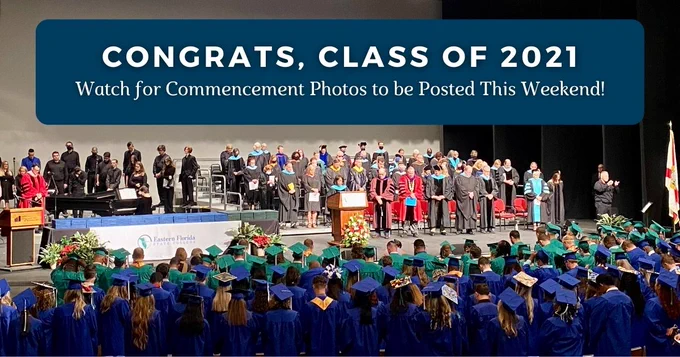 A graduation ceremony with a banner that reads, "Congrats, Class of 2021. Watch for Commencement photos to be posted this weekend!"