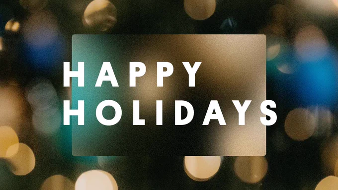 Dark background with blurred lights and "Happy Holidays" written in white.