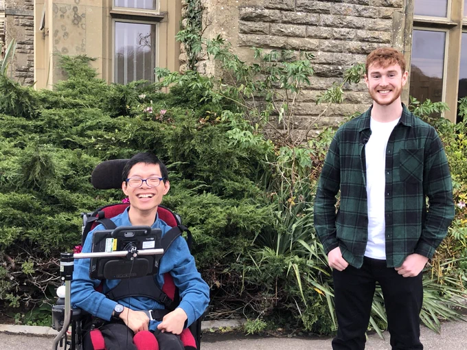 Student Leo smiling at the camera alongside his voice donor Dan