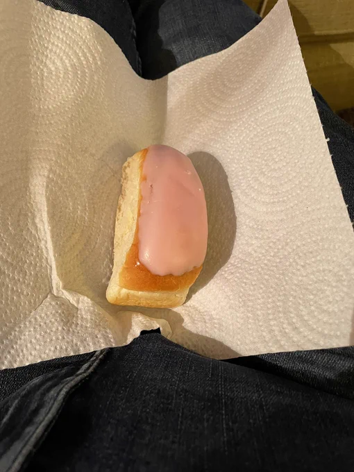 Photo description 
It’s an iced bun on some kitchen roll. No link to the post apart from it’s what I’m about to eat. The icing is pink and there’s jam inside. Someone’s been to Marksies.