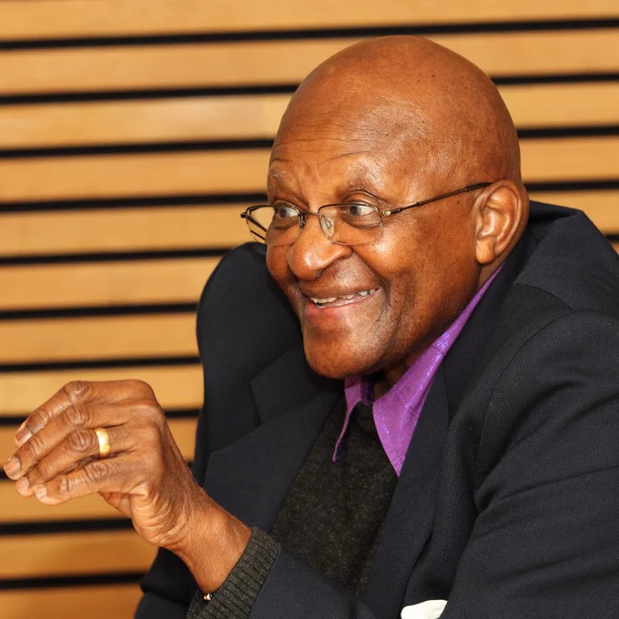 This is a photo of Archbishop Desmond Tutu at a Skoll Foundation event. He's alone in this picture speaking.