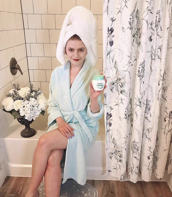 Girl in bathroom with pond’s moisturizer