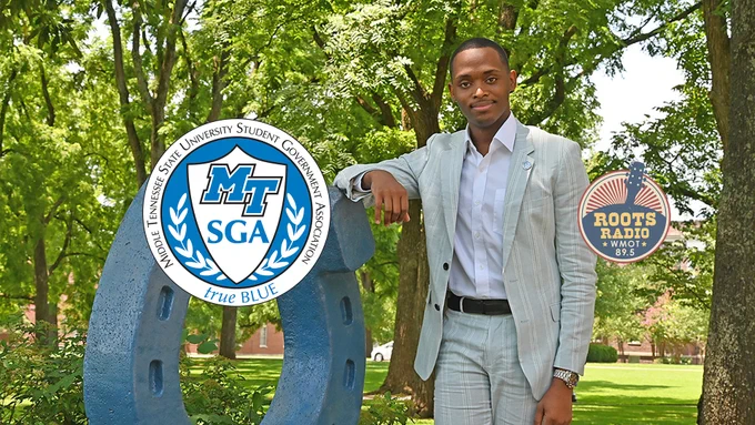International student Winton Cooper, the 2021-22 Middle Tennessee State University Student Government Association president, poses with the university's "Blue Horseshoe" in Walnut Grove on campus in this July 2021 file image, which also includes the SGA and WMOT-FM Roots Radio 89.5 logos. Cooper, a senior from Nassau, Bahamas, majoring in environmental science, is the guest on the "MTSU On the Record" program airing on MTSU's WMOT-FM Roots Radio 89.5 Tuesday, Dec. 28, and Sunday, Jan. 2. (MTSU file photo by Jimmy Hart)