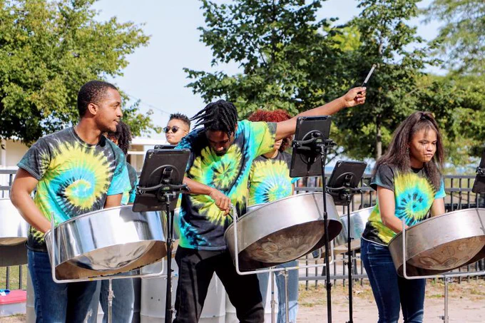 A steel pan troupe performs