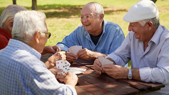 Men playing cards at a park