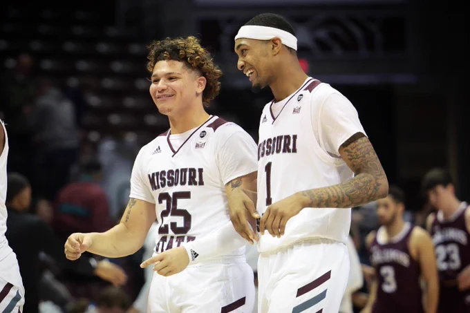 Players walk off the court smiling