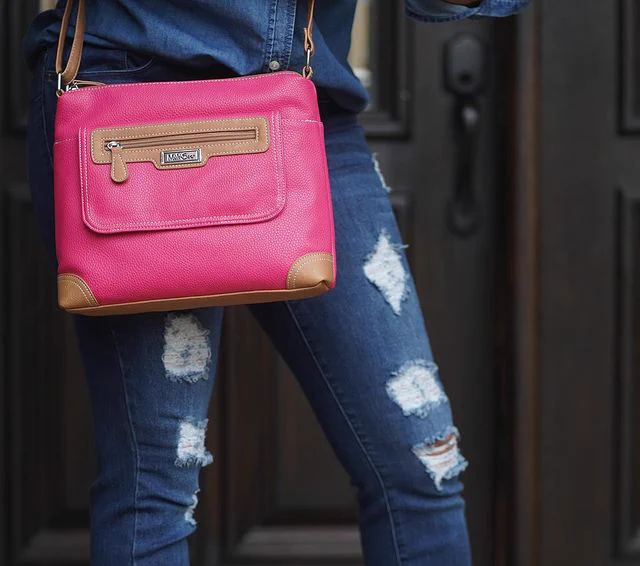 @madukessharon rocking her Fruit Punch Large Laredo Crossbody Bag with a jean button down shirt and ripped jean pants. 