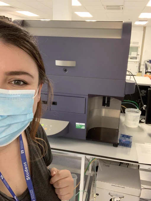 Scientist in the lab with a flow cytometry machine