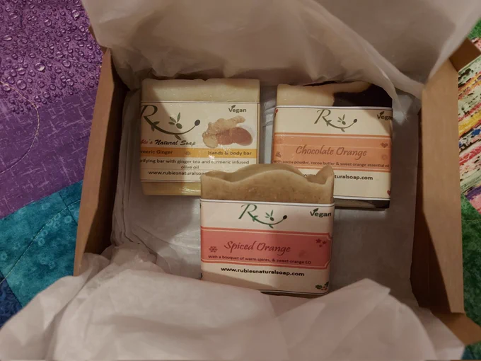 A box containing three beautiful bars of homemade soap- scents are spiced orange, turmeric ginger, chocolate orange