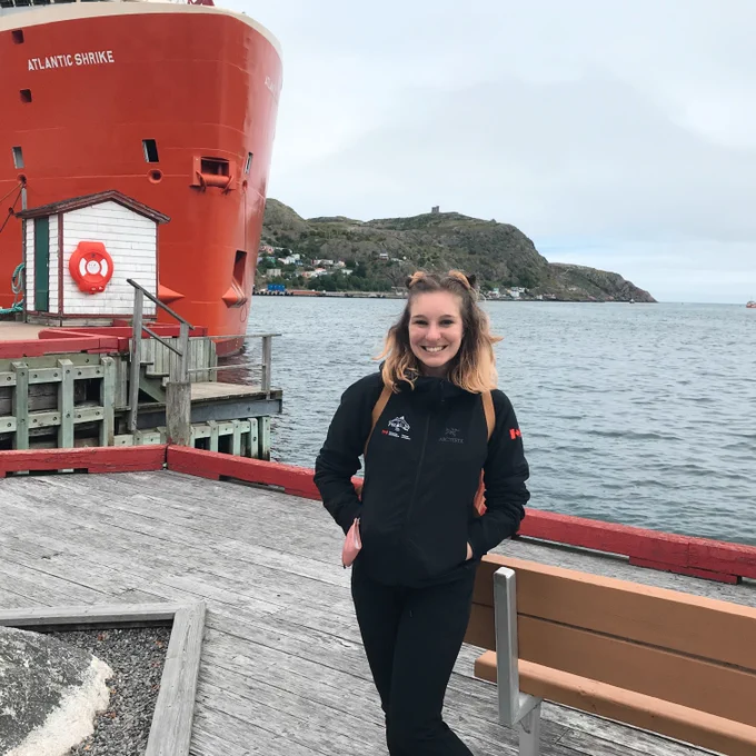 The artist Emma Smith in front of the ocean