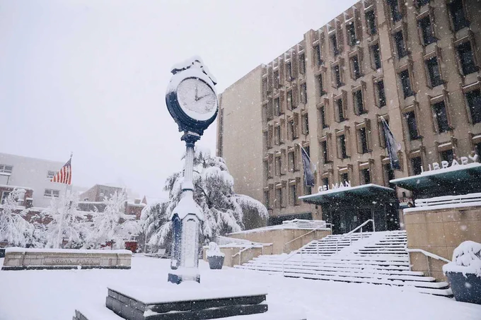 GW clock and Gelman Library covered in snow