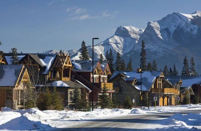 rustic houses along a street in a snowy mountain town