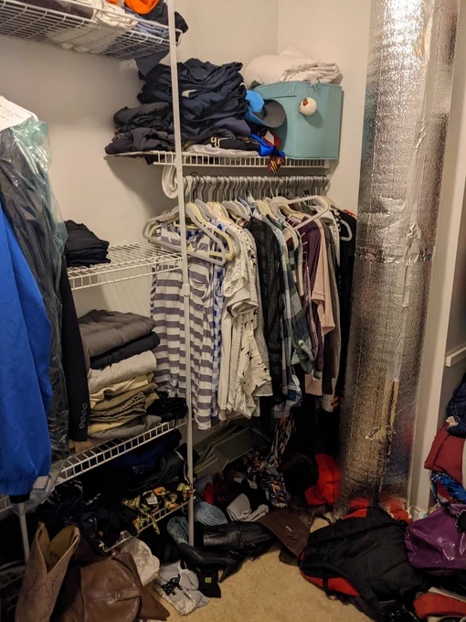 Closet before. One hanging rack. Few shelves. Very messy.
