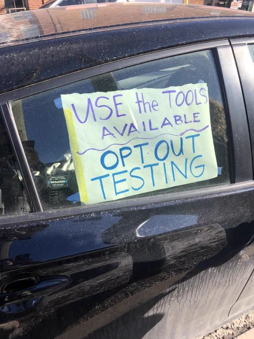 CTU caravan protest sign: “use the tools available. Opt-out testing”.