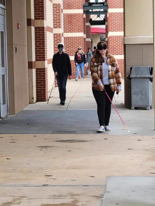 O&M students practicing sidewalk travel by a mall