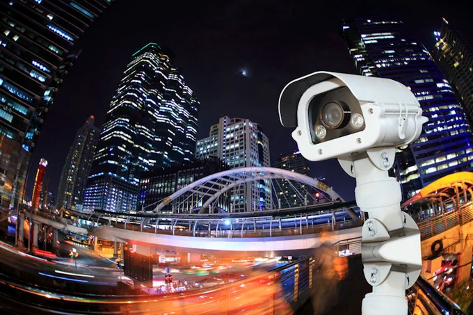 Traffic camera against a backdrop of a city at night