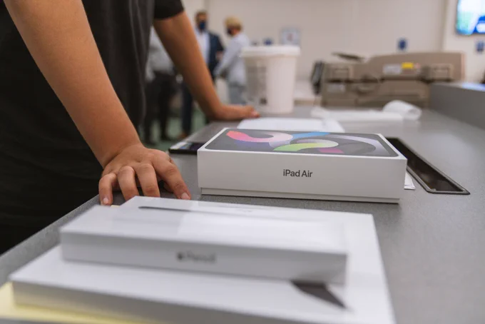 Photo of Apple iPad Air and student hands. 