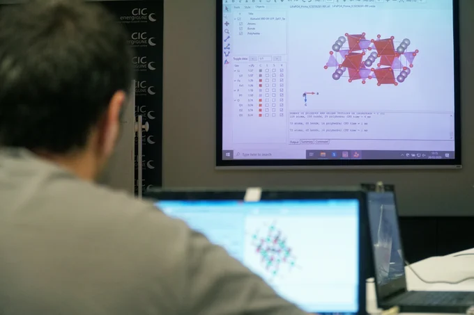 An image of a researcher looking at a structure on a screen.