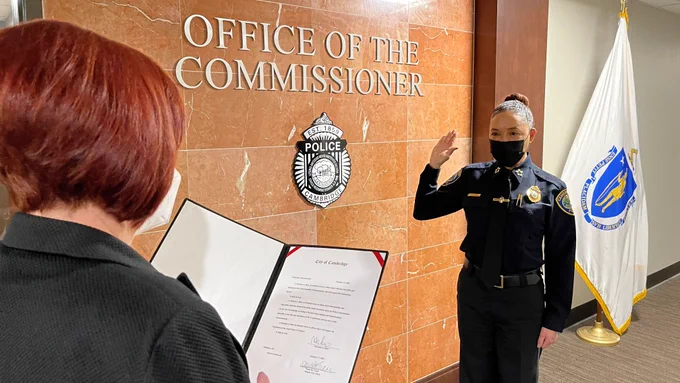 Police Commissioner Elow being sworn in by the Deputy City Clerk