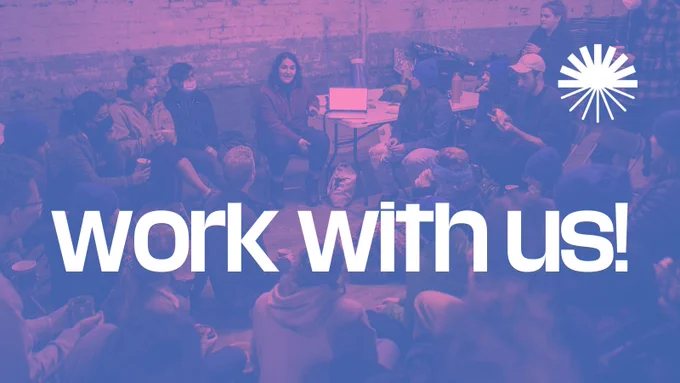 blue/pink duotone photo of a group of people sitting in a circle at a workshop. White text on top reads: work with us!
