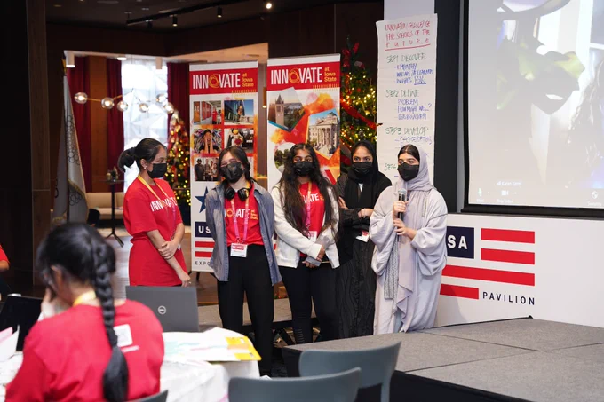 High school students present at a program in Dubai