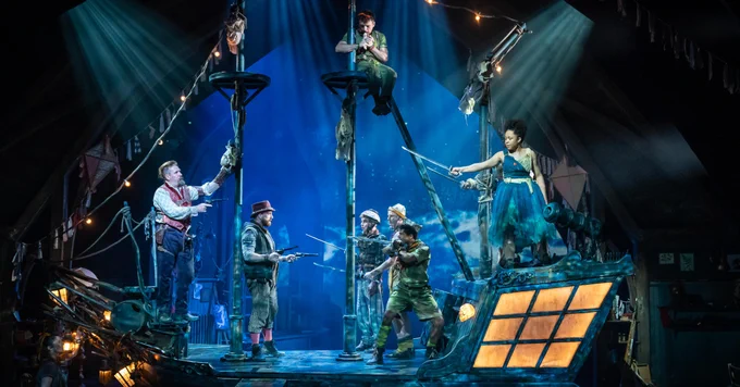 The cast of Wendy and Peter Pan in costume on stage. They are standing on the Jolly Roger pirate ship and look set for a battle.