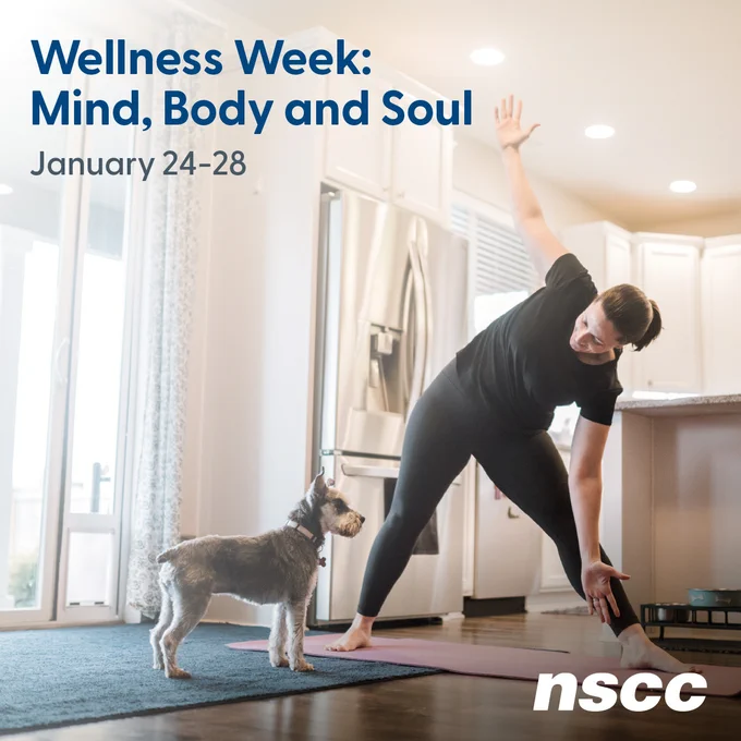 A woman is practicing a yoga pose in her home kitchen. Her small dog looks on. Blue text on the image reads: Wellness Week: Mind, Body and Soul