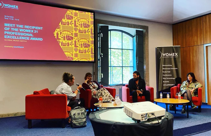 A panel discussion between four people - the topic is "Meet the recipient of the womex 21 professional excellence award"